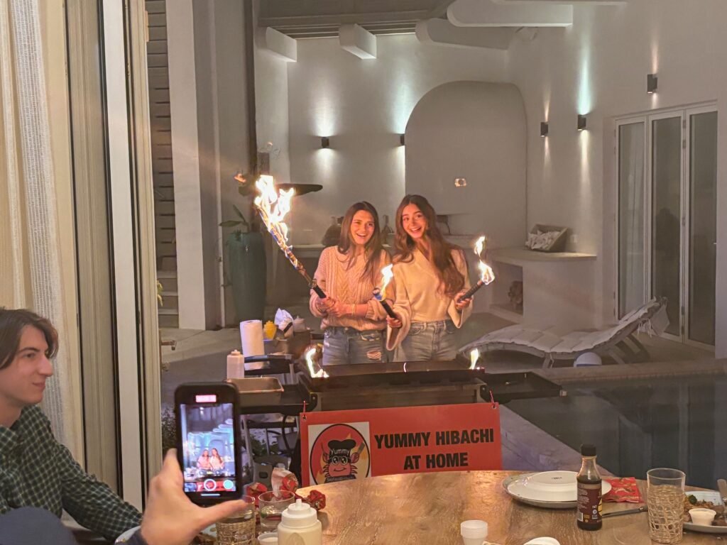 Hibachi chef cooking fried rice on a portable grill at a vacation rental