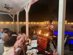 Guests watching a live hibachi show in their backyard in 30A Florida