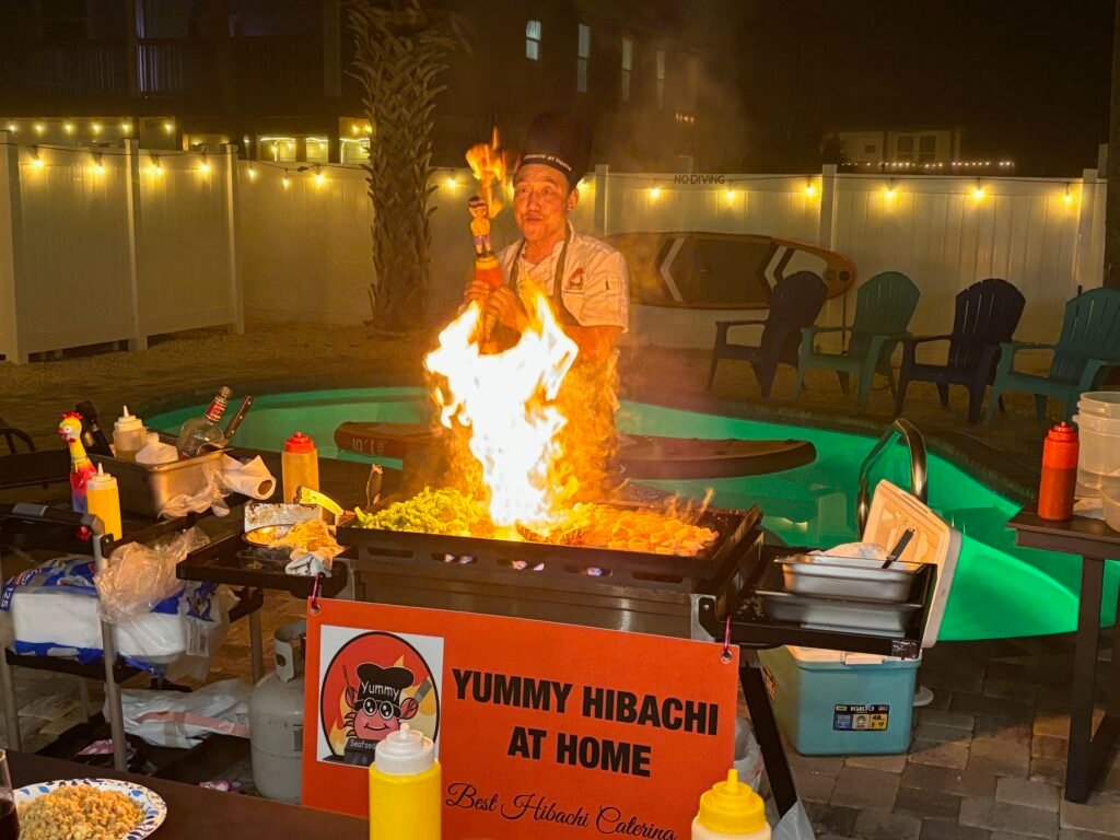 Private hibachi chef performing the onion volcano at a home party