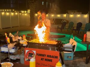 Private hibachi chef performing the onion volcano at a home party